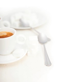 Italian espresso coffee fresh brewed macro closeup with sugar cubes