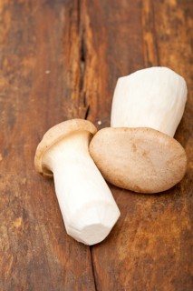 Bunch of fresh wild mushrooms on a rustic wood table