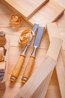 Carpenter's chisel and plane on wooden boards