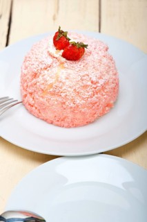 Fresh pink strawberry and whipped cream dessert macro close up