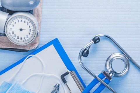 Blood pressure monitor clipboard with blank sheet of paper stethoscope medical concept