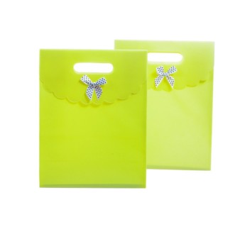 Two green paper bags against a white background