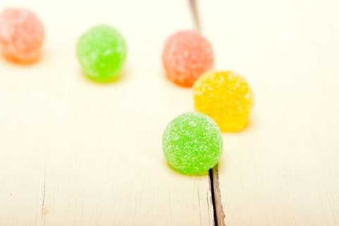 Sugar jelly fruit candy over white wood table