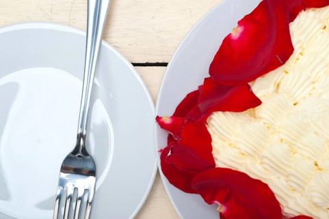 Whipped cream mango cake with red rose petals