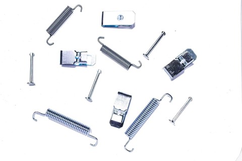 Repair kit of springs and clips for parking brake pads on white isolated background