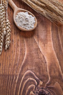 Copyspace image Wooden spoon with ears of wheat on old wooden boards