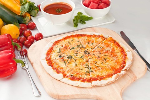 Italian original thin crust pizza Margherita with gazpacho soup and watermelon on side