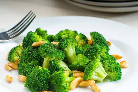 Fresh and vivid sauteed broccoli and almonds very ealthy food