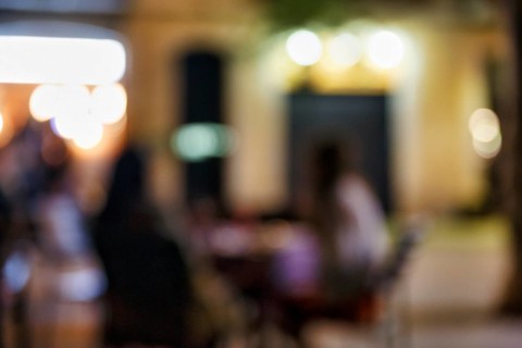 Illuminated street cafe at night