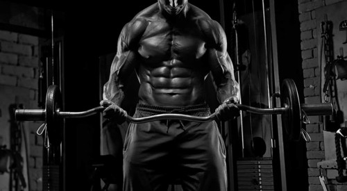 No name strong athletic man pumping up muscles