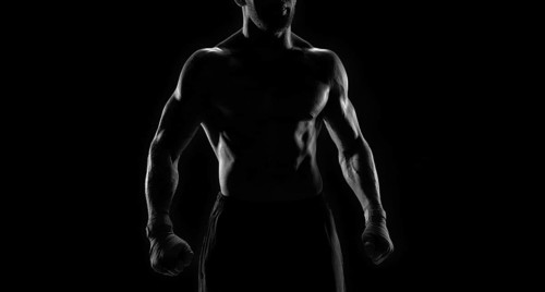 Noname image of a kickboxer on a dark background. The concept of mixed martial arts. MMA