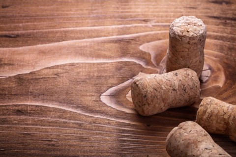 Champagne cork on vintage wooden board with copy field