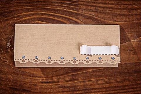 Envelope for invitation on wooden table