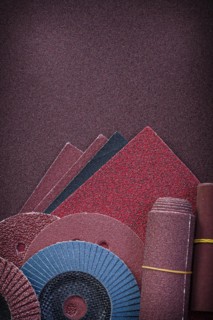 Heap of abrasive tools on polishing paper