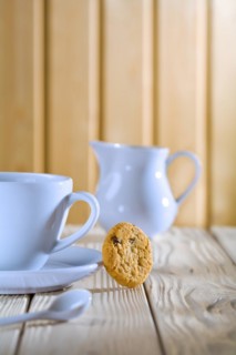 Blue coffee cup and jug on a white table
