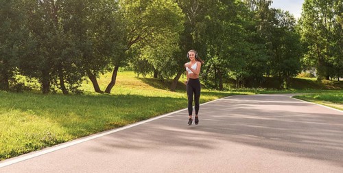 Sports girl jogging in the park. The concept of a healthy lifestyle. Sports Equipment. Fitness style advertisement. mixed media