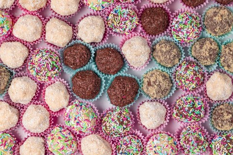 Light and dark rum balls with various sprinkles photographed from above