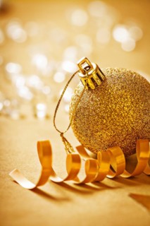 Large gold-coloured Christmas bauble very close-up view