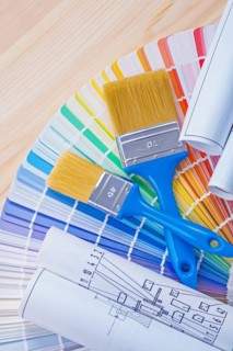 Blue prints and paintbrushes on opened colour palette