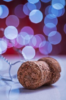 Champagne cork on white table and blurred background with bokeh