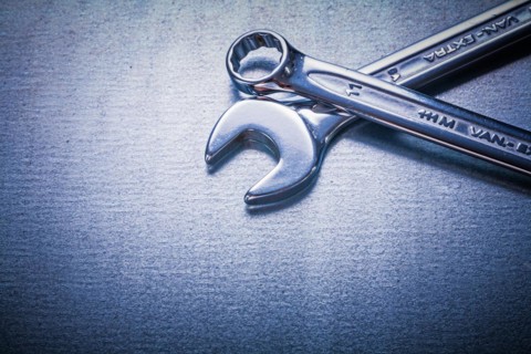 Flat spanner and hook spanner on a metallic background Design concept