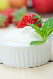 Organic Greek yogurt and strawberry over white rustic wood table