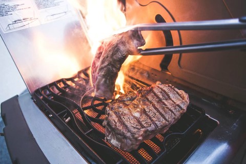 A steak on a gas barbecue in the fire