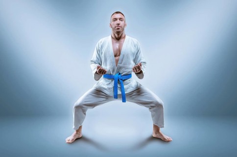 Professional wrestler is wearing a kimono. He is preparing to demonstrate the kata. The concept of mixed martial arts