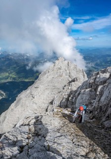 Climber on a via ferrata secured with steel rope