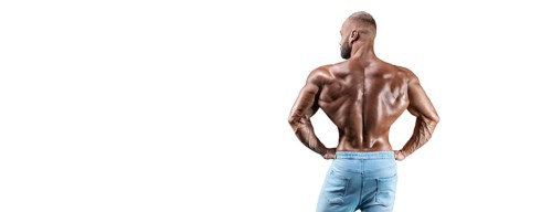 Sportsman posing on a white background in jeans. Back view. Fitness