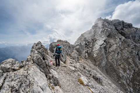 Mountaineer on a narrow rocky ridge