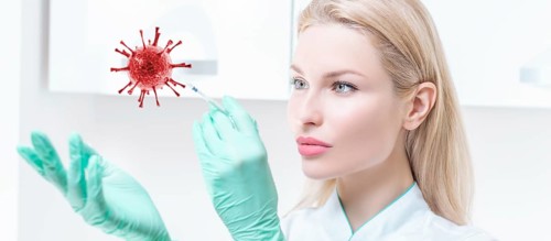 Portrait of a blonde girl in a medical gown with a syringe in her hands. Covid vaccine concept. Epidemic