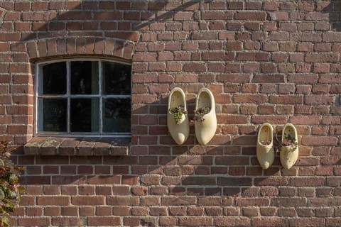 Wooden shoes as decoration on a stable wall