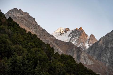 Glaciated mountain peak at sunset