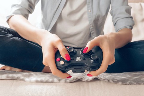 Image of hands holding a game joystick. Game concept. Stay home.