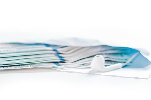 Pack of hundred-dollar bills along with a bug lie in an envelope. The concept of bribery and corruption.