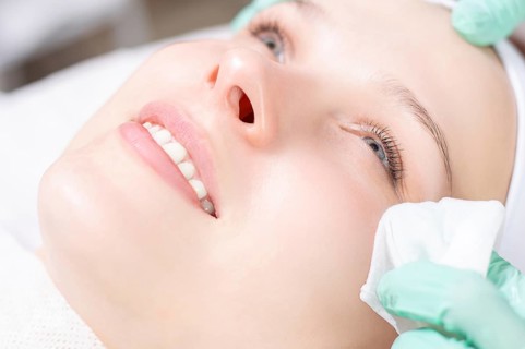 Beautiful girl gets face peeling. Skin health concept. Beauty salons.