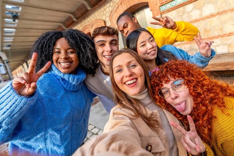 Friends pulling faces while taking a selfie in the city