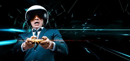 Portrait of a man in a suit and helmet of a pilot with a joystick in his hands. He enthusiastically plays a computer game. Game space. Game concept.