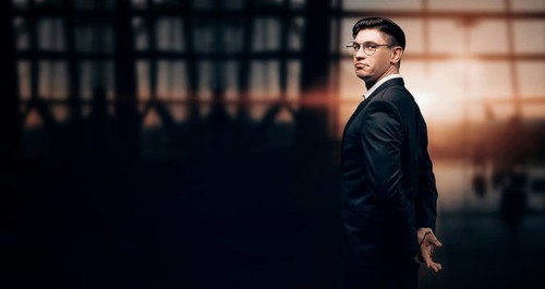 Portrait of a man in a business suit. He is standing at the airport and looking at the camera. Airline concept. VIP transportation. Private airlines. Charter flights.