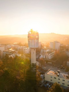 Aerial view A water tower stands in the centre of the city view at dawn