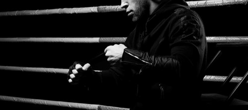Mixed martial artist wraps bandages around his fist. Concept of mma