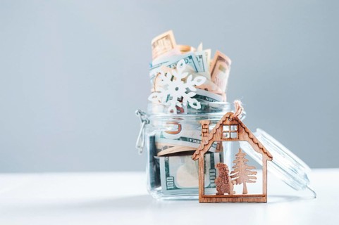 Glass piggy bank full of money. Christmas and New Year concept. Gift expenses.