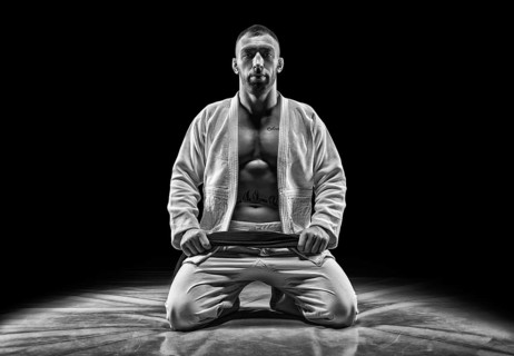 Professional athlete sits in the gym. Concept of karate