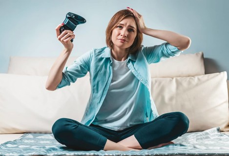 Portrait of a girl with a joystick in her hands. The concept of video games