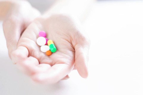 Image of pills on a female palm. The concept of medicine