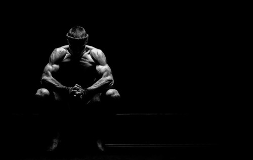 World champion in Thai boxing is sitting in the ring and getting ready for the next fight. The concept of sport