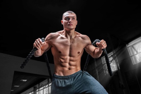 Portrait of an athlete who pulls the ropes. View from below. The concept of sport and healthy lifestyle.