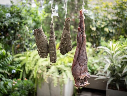 Llama shanks and leg of lamb over a smoker