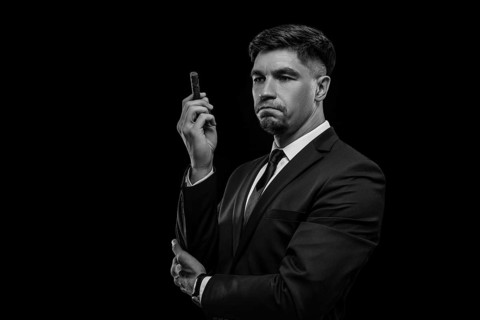 Portrait of a stylish man in a suit with a cigar. Business concept.